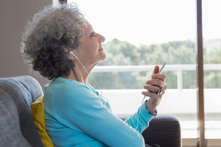 A senior woman with dementia enjoying the benefits of sensory stimulation.