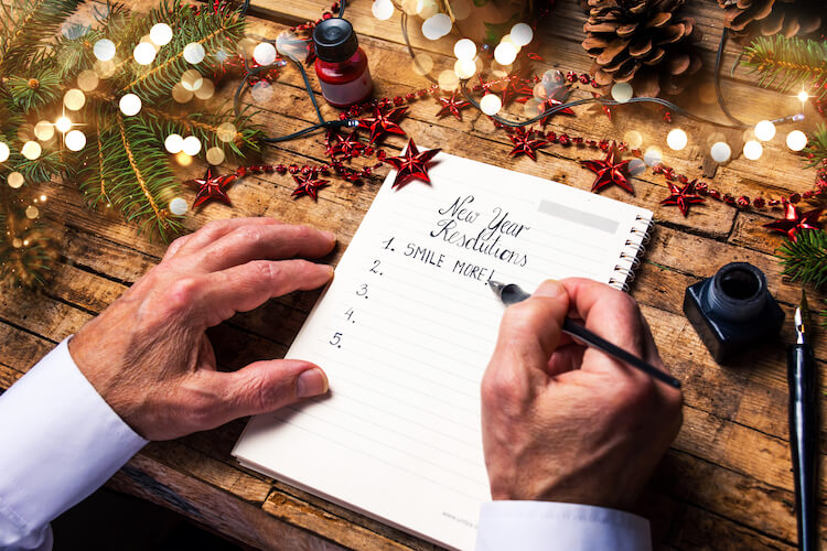 A senior man writes his new year’s resolutions