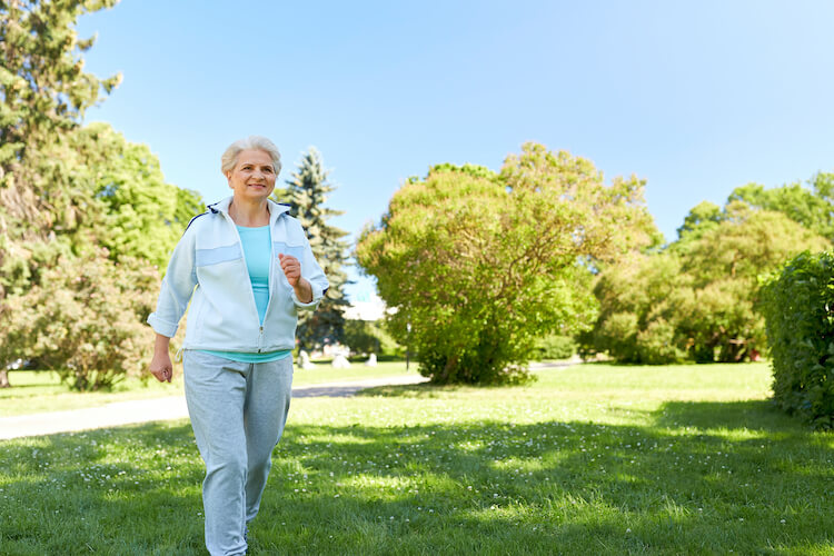 Happy senior woman exercising outside.